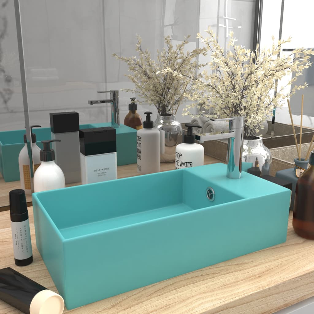 Light blue ceramic sink with overflow