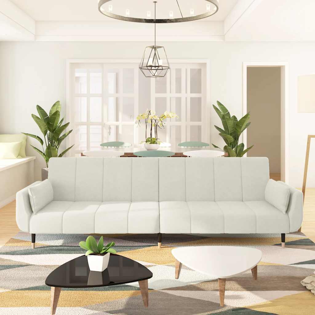 2-seater sofa bed with two burgundy velvet pillows