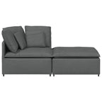 Sofá modular con reposapiés y cojines de tela gris oscuro
