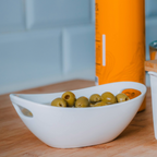 Taça oval em porcelana com pegas para snacks.