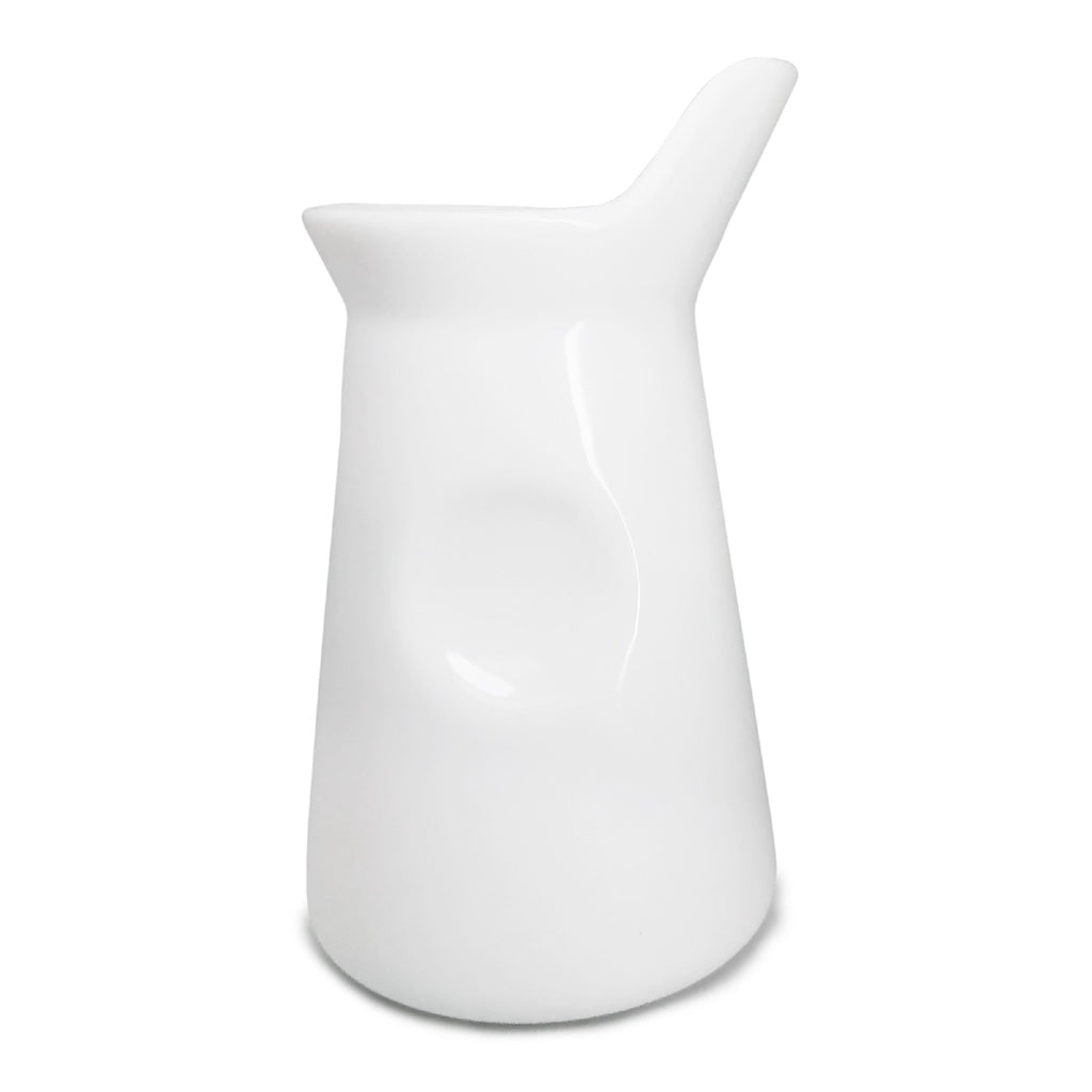 White porcelain milk jug for coffee or tea