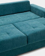 Blue pull-out sofa bed with cushions for guests