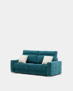 Blue pull-out sofa bed with cushions for guests