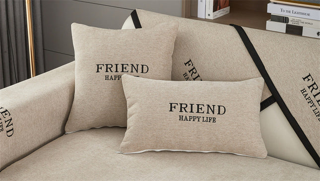 Individual sofa covers with Friend embroidery in neutral colors