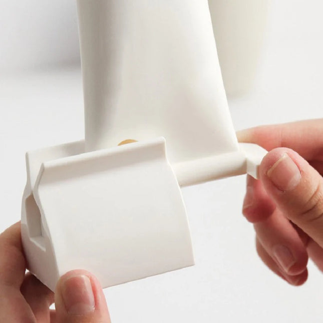 Toothpaste squeezer dispenser