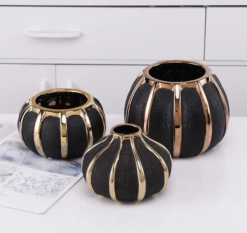 Modern black ceramic vases with gold stripes