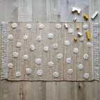 Jute and cotton rug with embossed polka dots and fringes