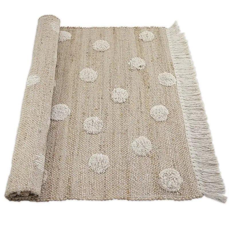 Jute and cotton rug with embossed polka dots and fringes