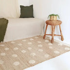 Jute and cotton rug with embossed polka dots and fringes