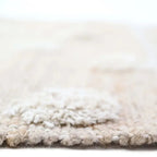 Jute and cotton rug with embossed polka dots and fringes