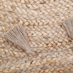 Round jute children's rug with pompoms