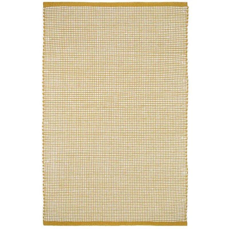 Hand-woven wool rug in a vibrant mango color