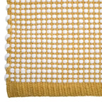 Hand-woven wool rug in a vibrant mango color