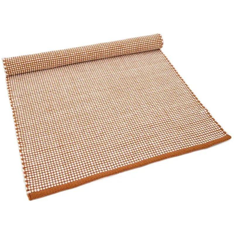 Natural wool rug with a graphic design in caramel