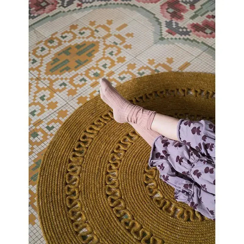 Round handmade wool rug with openwork design