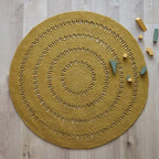 Round handmade wool rug with openwork design